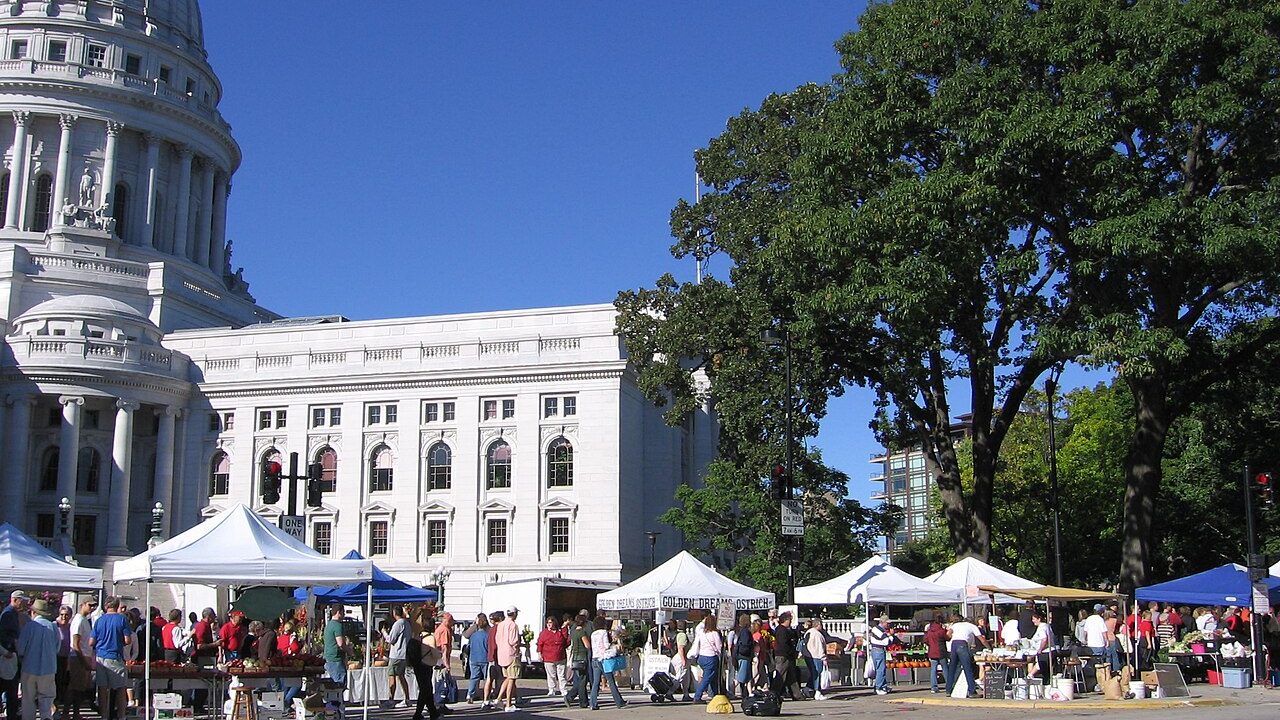 Busy Wisconsin farmers market with vendor tents