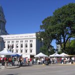 Busy Wisconsin farmers market with vendor tents