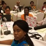 Participants seated around a table during a facilitated discussion
