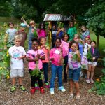 Children and families together in a neighborhood vegetable garden