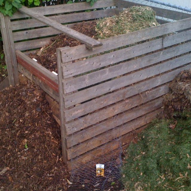 Wooden slatted backyard compost bin