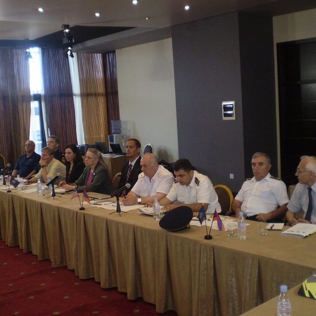 Professionals around a conference table during a sustainability workshop